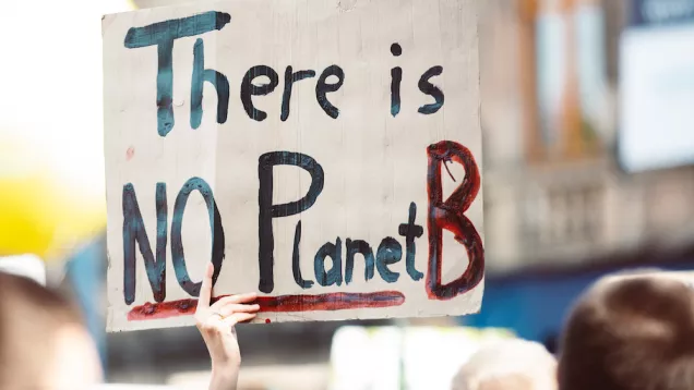 hand painted sign says No Planet B