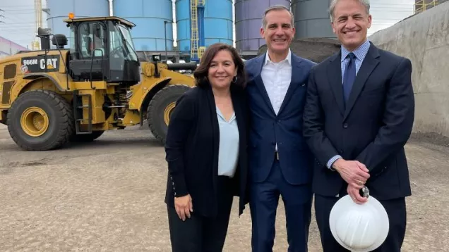 Commissioner Teresa Villegas Mayor Eric Garcetti and Board of Public Works President Greg Good in front of a bulldozer and silos at an asphalt plant 